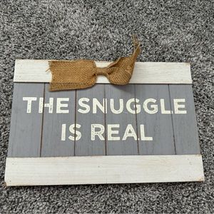 “The snuggle is real” wooden sign